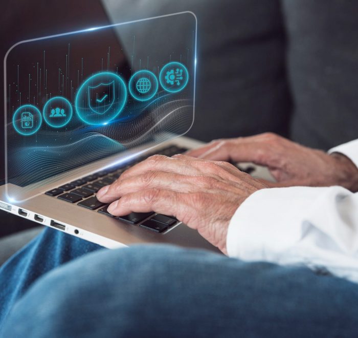 Person typing on laptop with holographic interface
