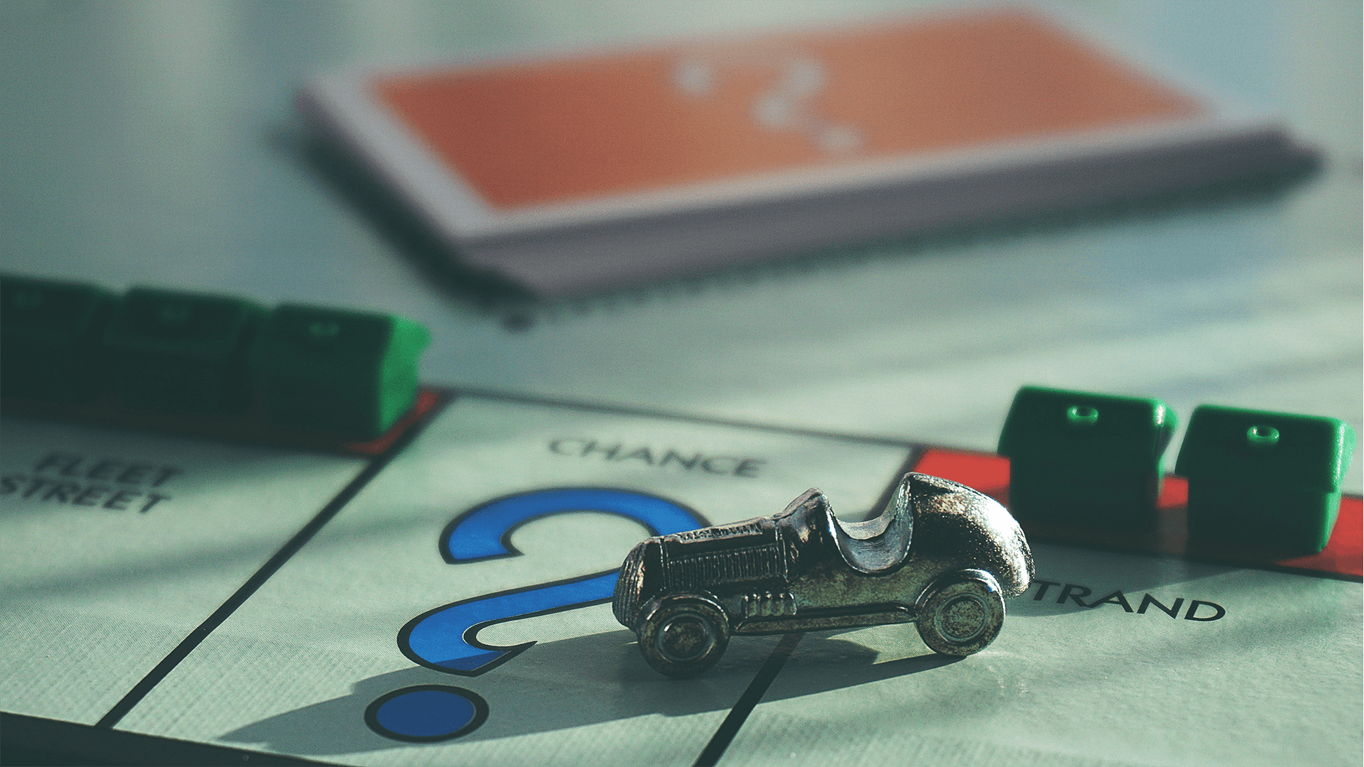 Metal car token on Monopoly Chance space