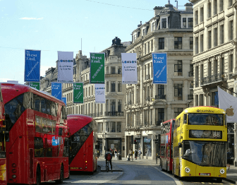 London street with red and yellow double-decker buses