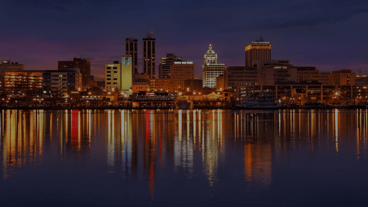 Nighttime city skyline reflected on river