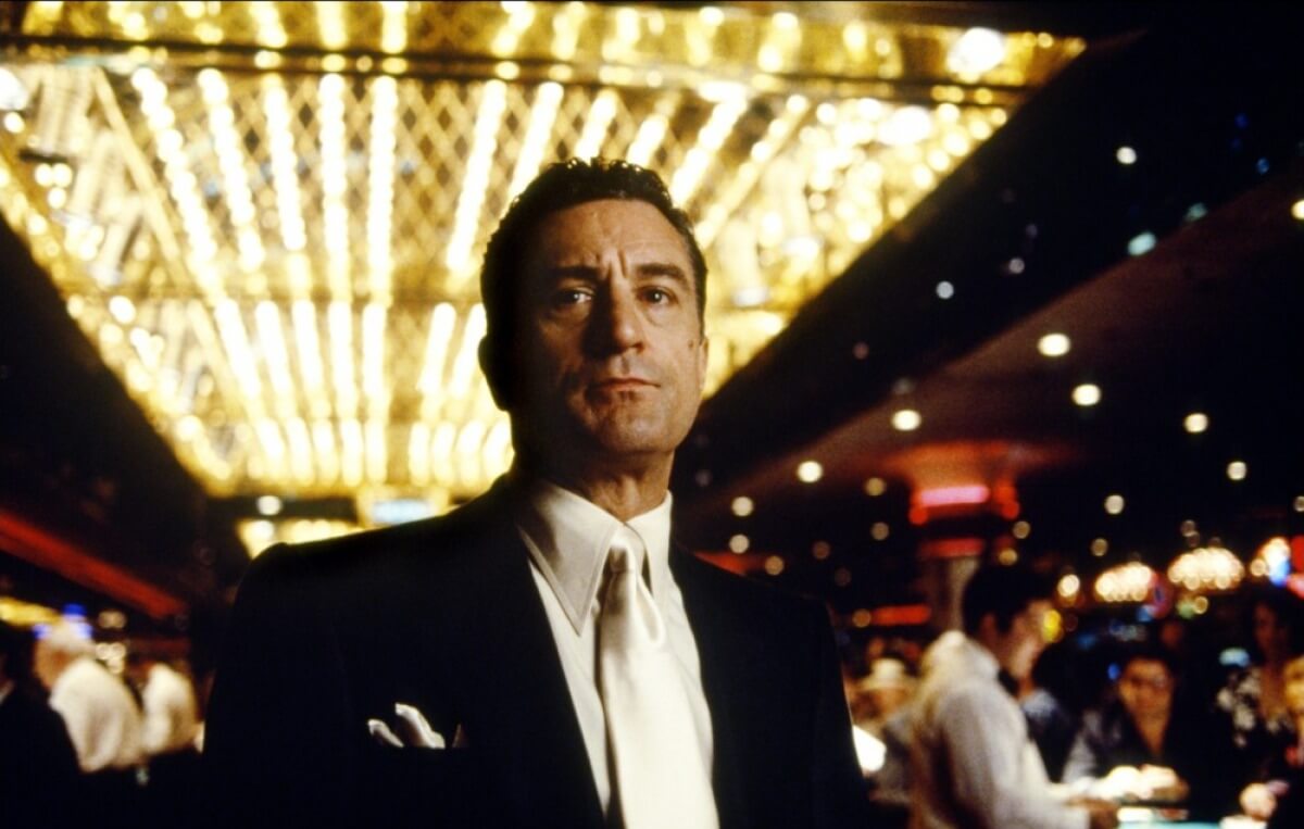 Man in suit standing in busy casino