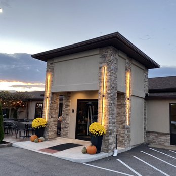 Building entrance with stone columns, mums, pumpkins