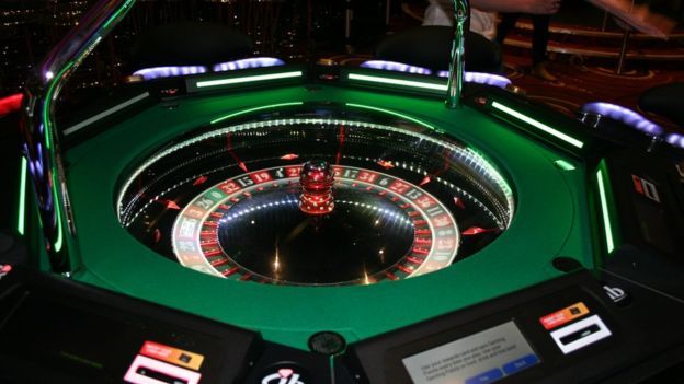 Casino roulette wheel with glowing green lights