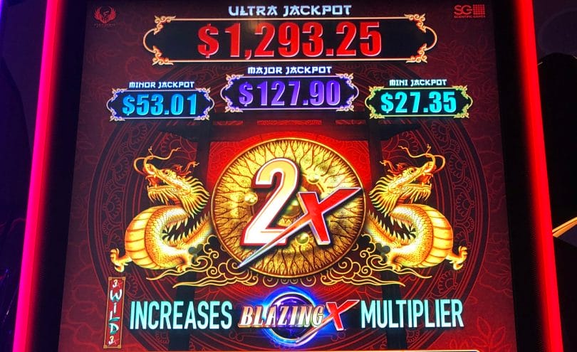 Slot machine screen displaying 2x multiplier and jackpots