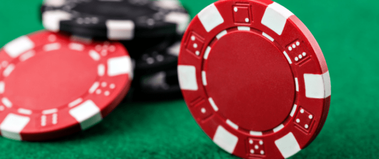 Red poker chips on green casino felt