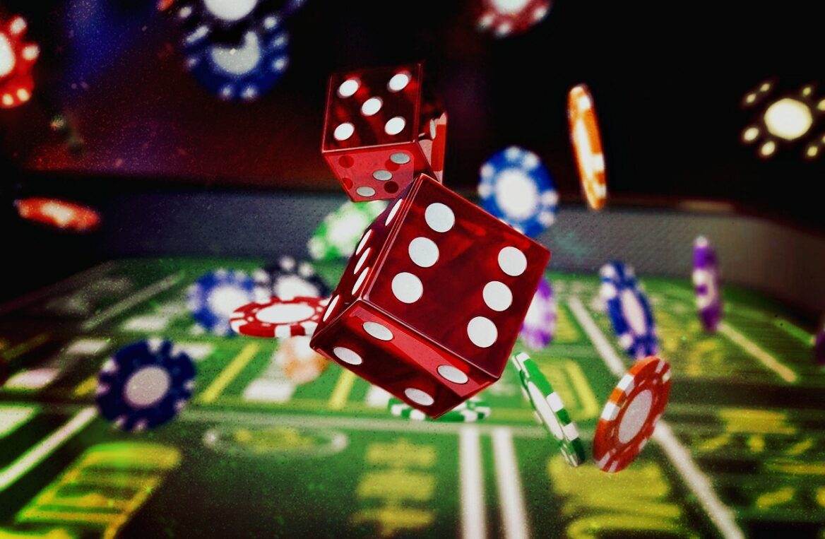 Red dice and poker chips on casino table