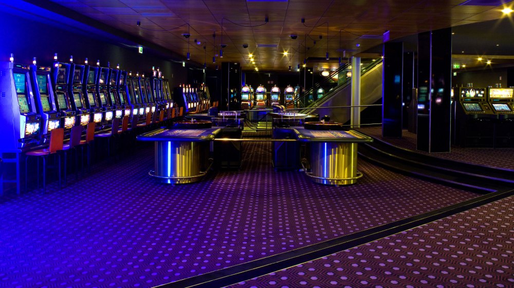 Empty casino floor with slot machines and tables