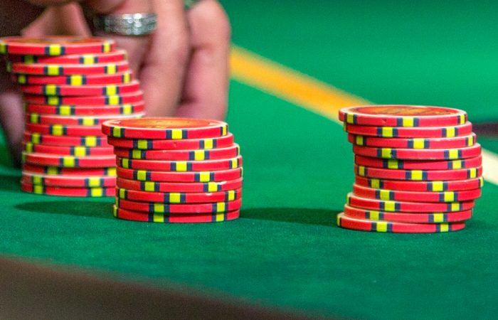 Red poker chips stacked on green felt