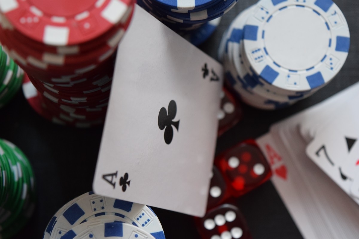 Ace of clubs with poker chips and dice