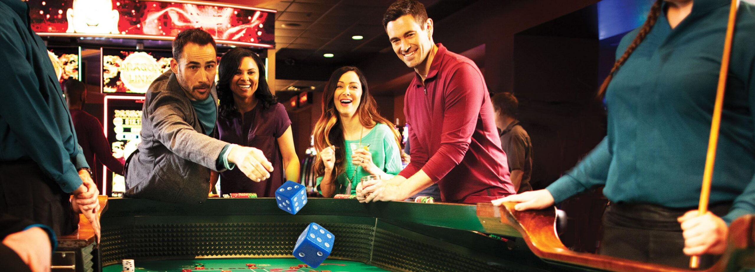 Group playing craps, tossing oversized blue dice