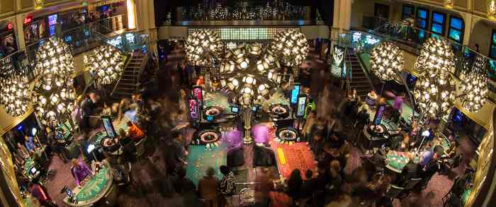 Bustling casino floor with ornate chandeliers