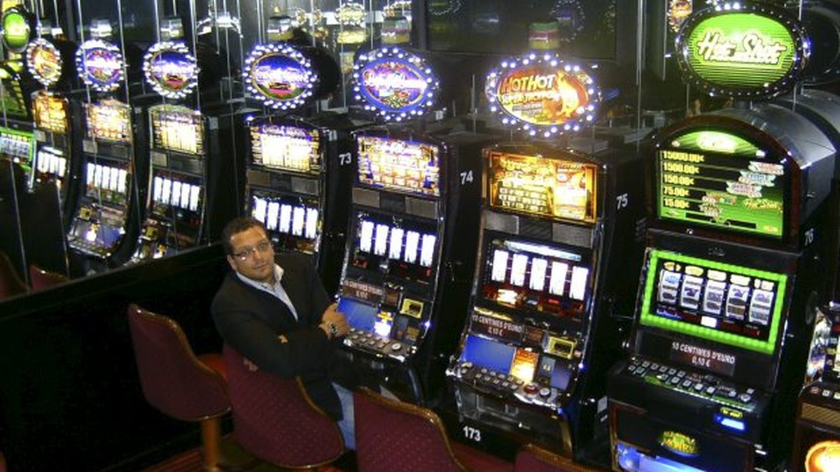 Person playing slot machines in casino