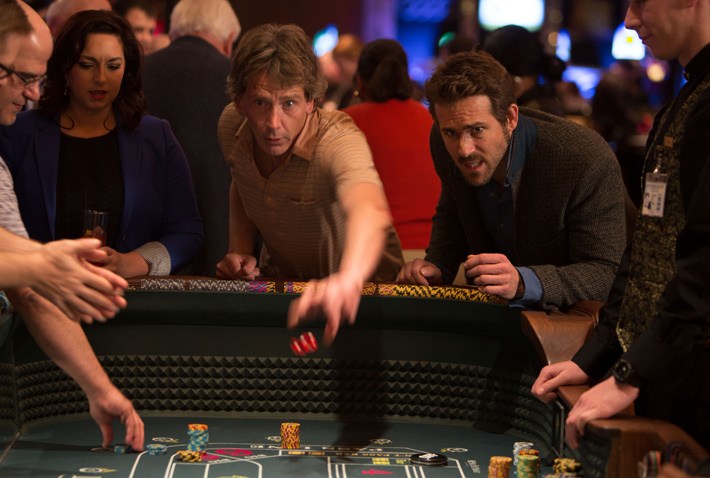 Group gambling at crowded casino table