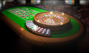 Roulette wheel and chips on casino table