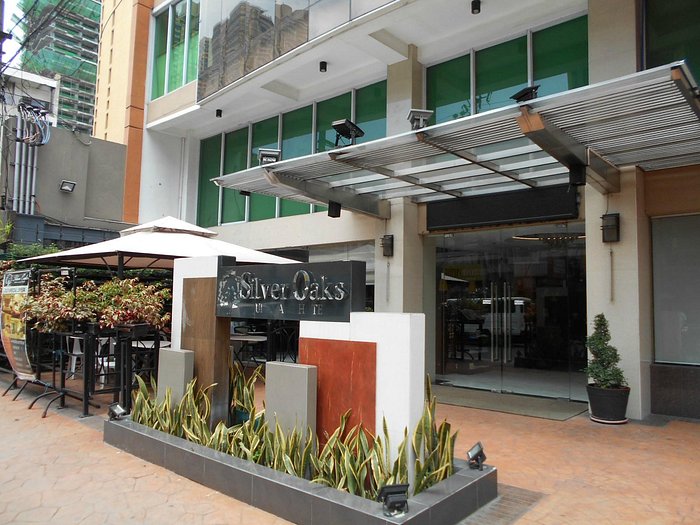 Building entrance with glass awning and planters