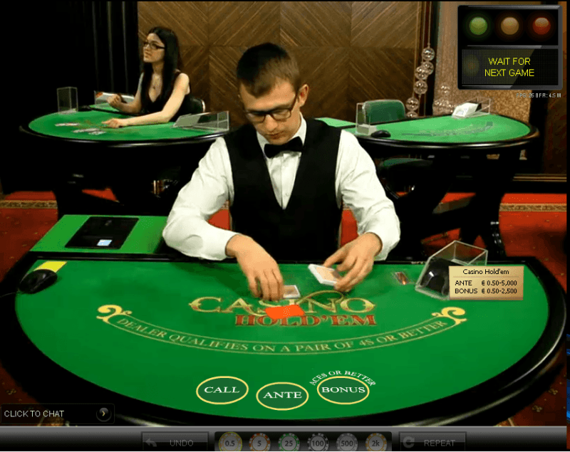 Casino dealer dealing cards at green table