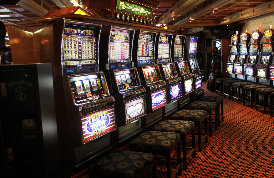 Row of casino slot machines with stools